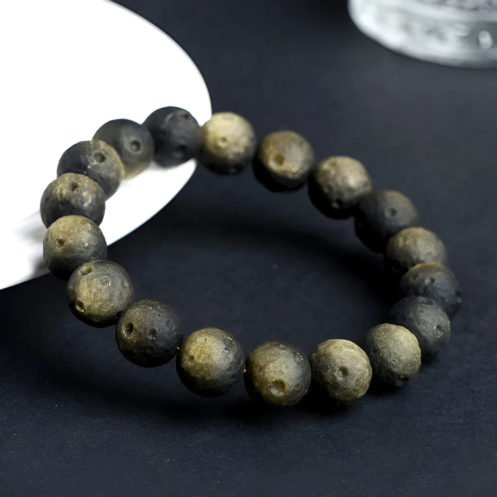 Obsidian ball bracelet with natural crater texture in silver stone meteorite colour with grinding finish