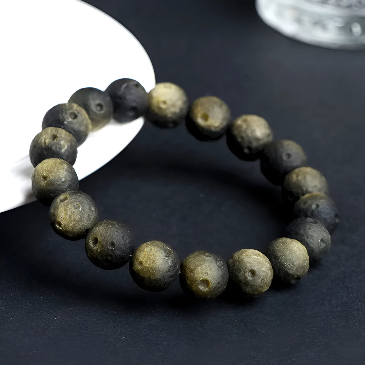 Obsidian ball bracelet with natural crater texture in silver stone meteorite colour with grinding finish