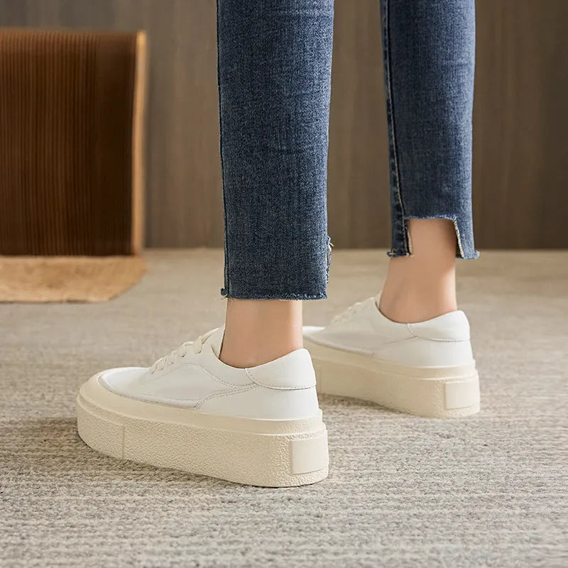 Women's black embossed leather platform sports shoes with a round toe and rubber sole.
