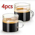 White modern double mouth transparent glass coffee cup set on a table.