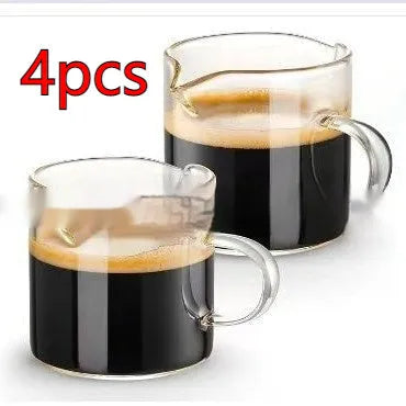 White modern double mouth transparent glass coffee cup set on a table.