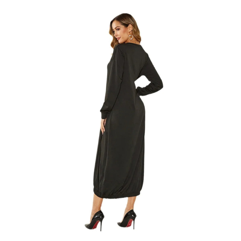 A loose-fitting, long black lantern dress with a lace-up detail at the crew neck, made from knitted polyester fabric.