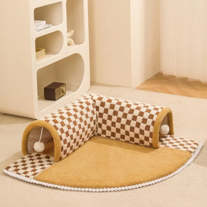 Brown plush plaid cat tunnel bed with central mat, showing collapsible tube design for indoor cats