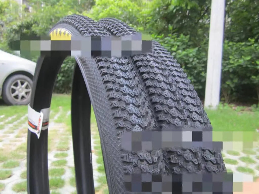 Ultralight black mountain bike tyre with puncture proof tread, shown in 26, 27.5 and 29 inch sizes.