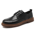 Black and brown round-toe casual leather shoes with visible stitching and flat rubber soles.