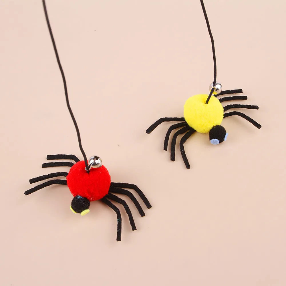 Red and yellow cat hanging door toy with elastic rope, feathers, a bell, and a spider attachment.