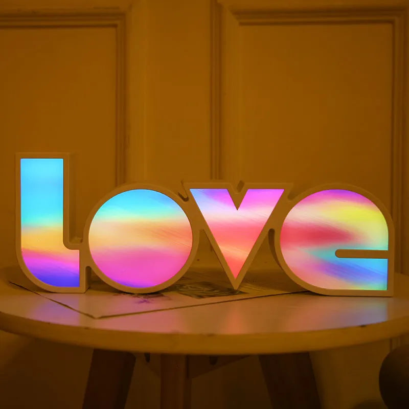 LED LOVE Light with colourful rainbow lampshade on a desk