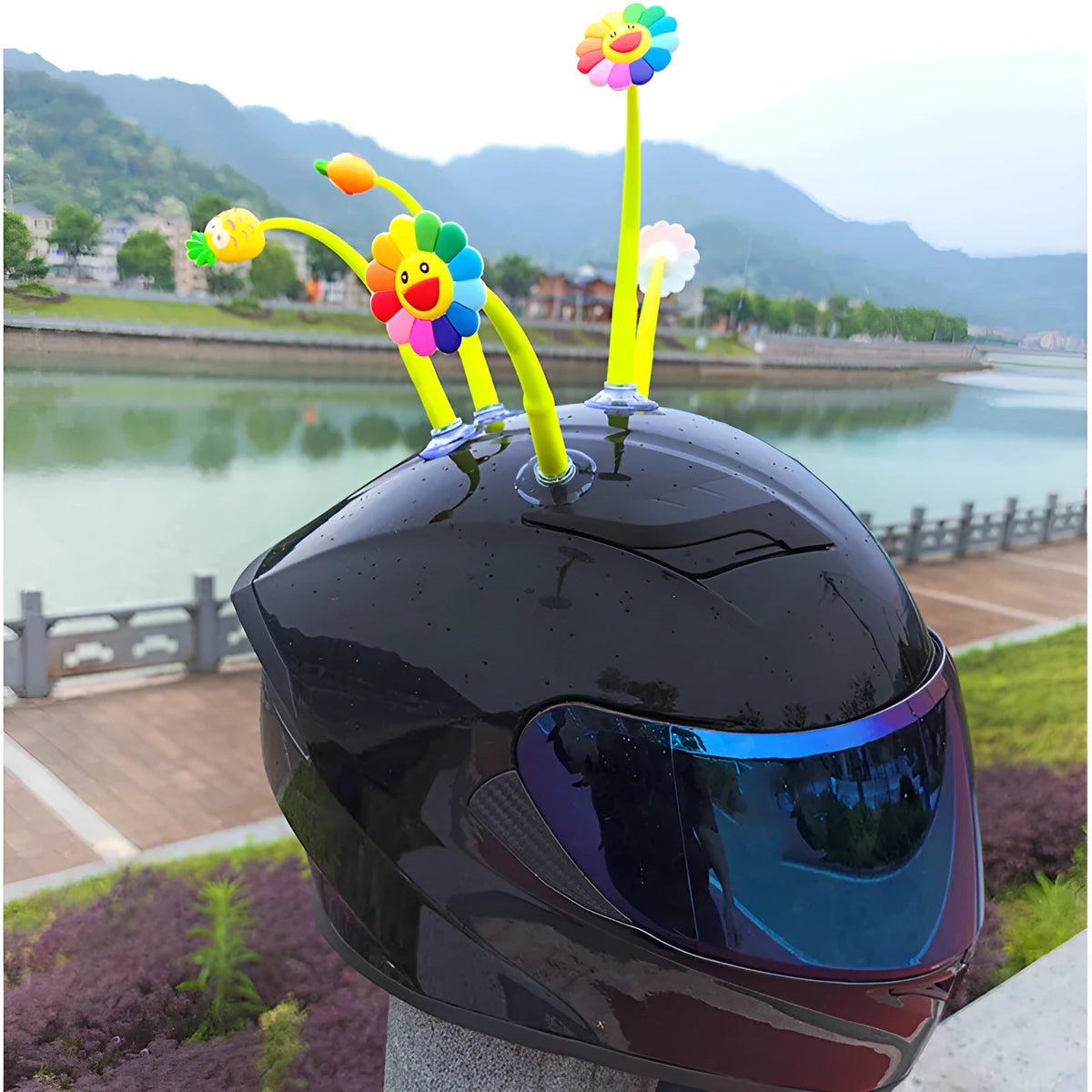 Yellow silicone sunflower helmet decoration with suction cup attachment swinging from motorcycle helmet