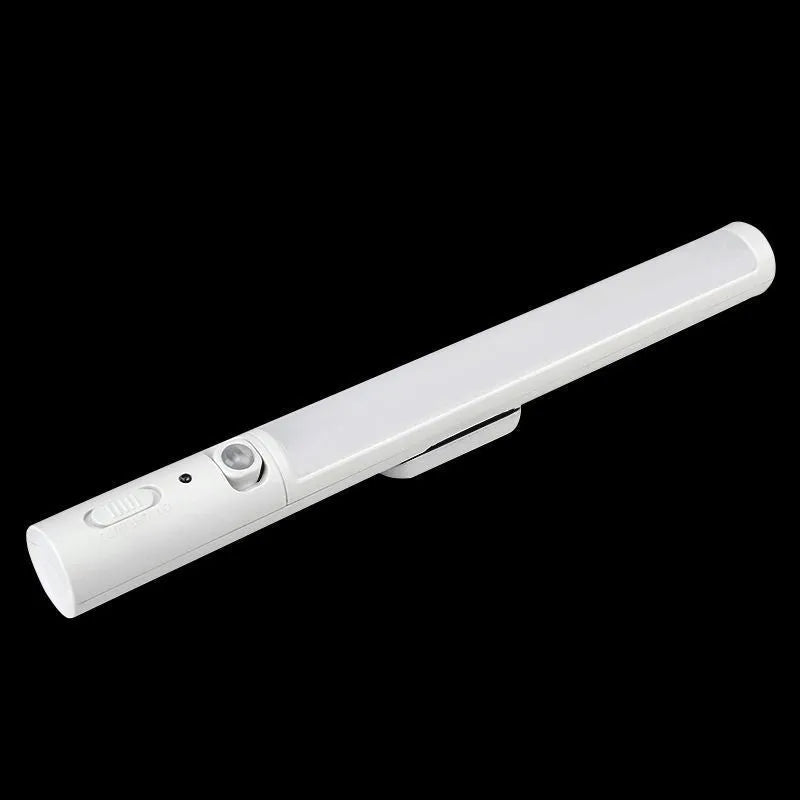 Long white LED human body induction cabinet light with magnetic strip on back for wall or wardrobe mounting.