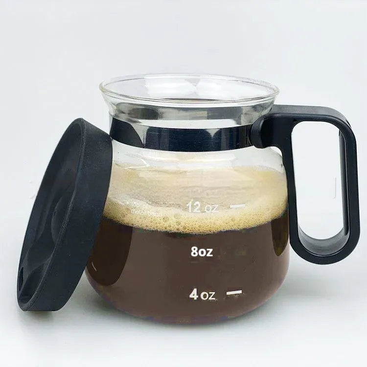 Transparent borosilicate glass coffee maker with a black silicone cover.