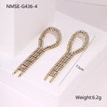 Women's gold heart and star shaped earrings with a diamond tassel detail on a white background.