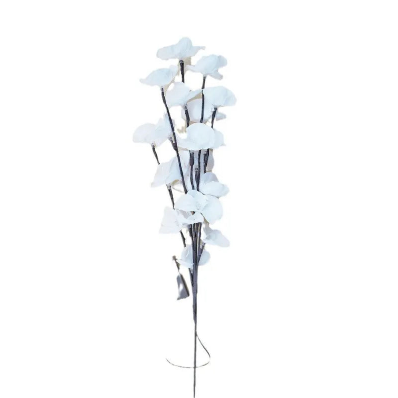 Pink phalaenopsis branch LED decorative light with fabric stem and plastic housing on wooden table