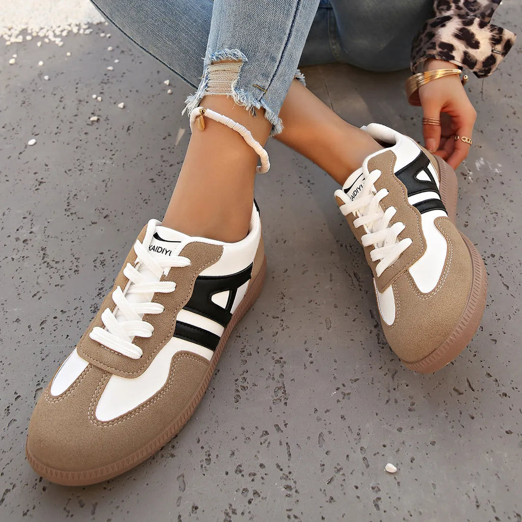 Women's retro lace-up jogging shoes in black, grey, and khaki colours showing round toe and platform heel.