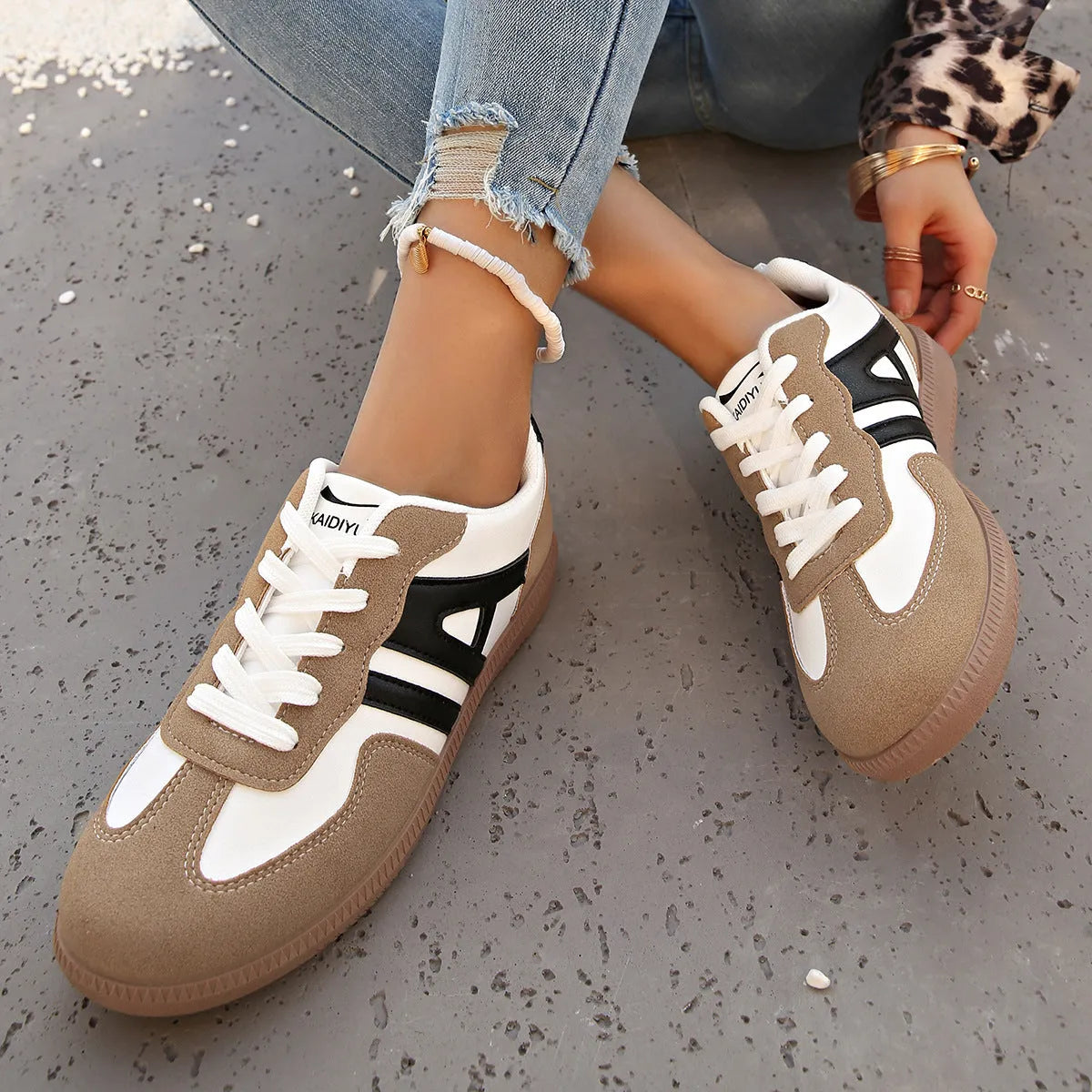 Women's retro lace-up jogging shoes in black, grey, and khaki colours showing round toe and platform heel.