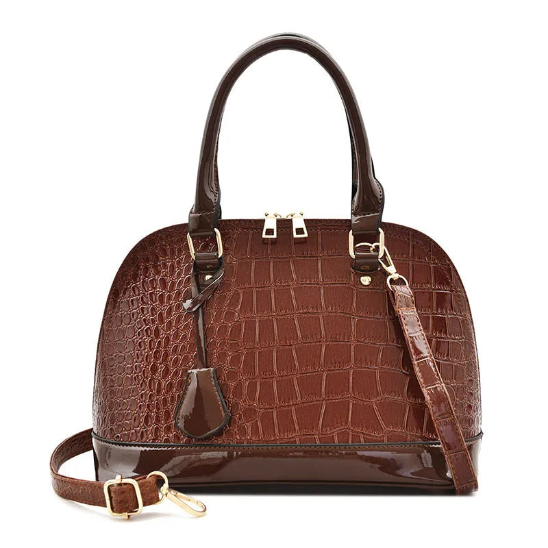 Shiny PU shoulder bag in shell shape showing black, brown, and red colour options