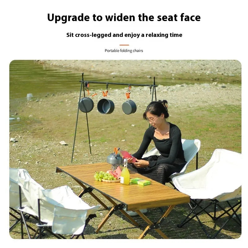 Folding outdoor chair with steel frame and Oxford cloth seat in a neutral colour.