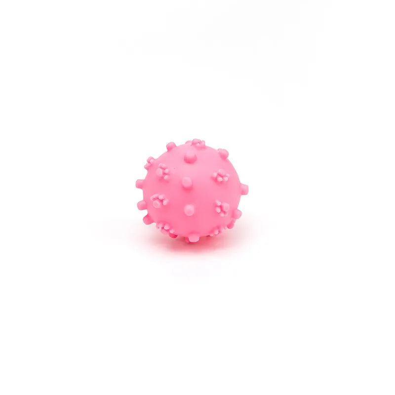 Bright coloured spiked dog ball with paw print dimples measuring 2 inches diameter for small dogs