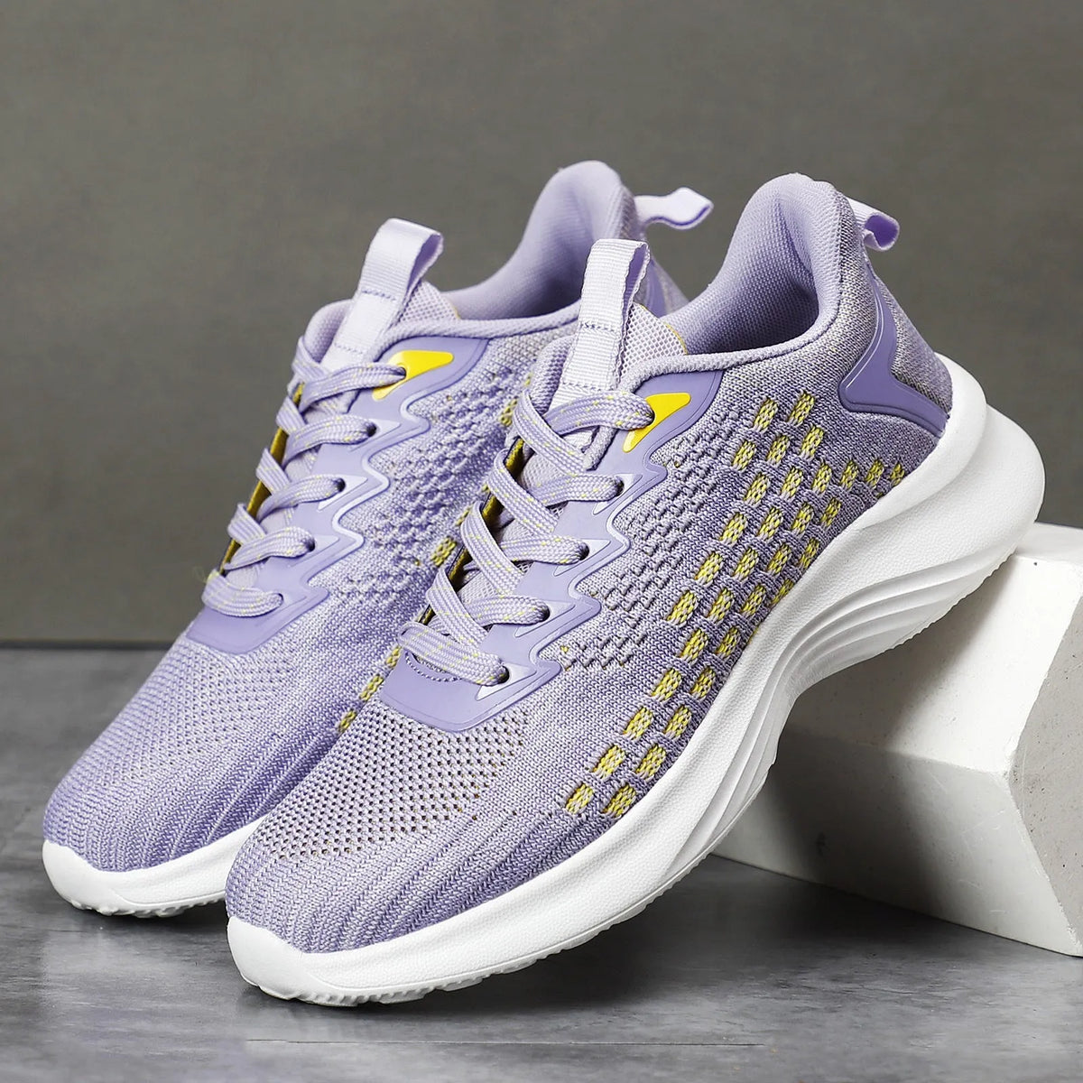 Women's Lavender Purple Flyknit running shoes with mesh upper and striped pattern on an EVA sole.