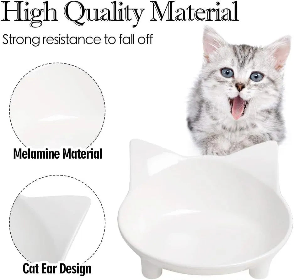 Set of four white shallow melamine pet bowls with black non-slip rubber bases on a table.