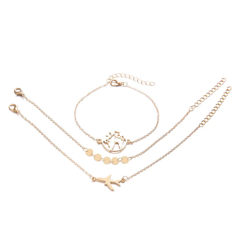 Three Bohemian-style bracelets with aircraft map and heart charms in gold electroplated finish