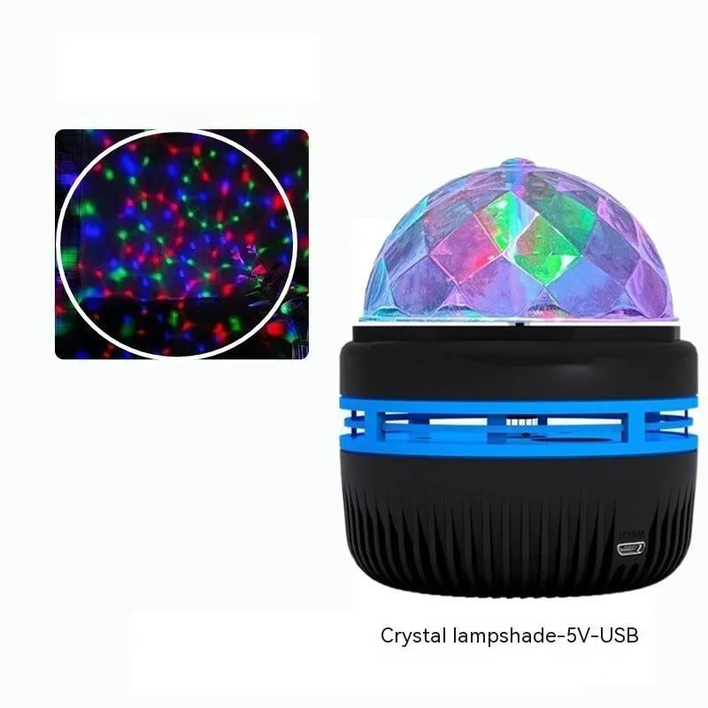 Mini crystal magic ball atmosphere projector showing starry sky and aurora light projection on a dark background.