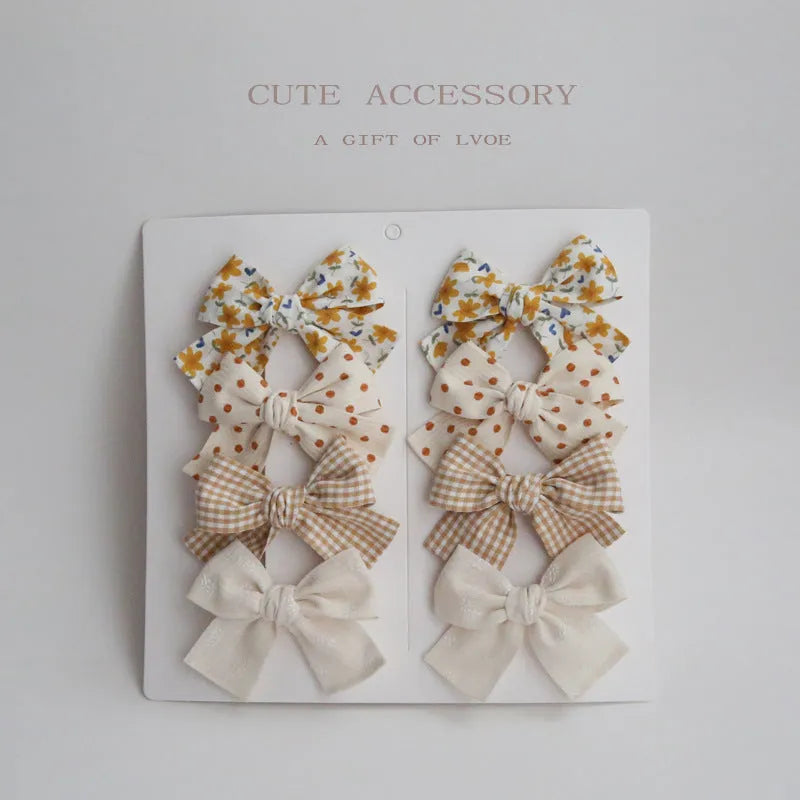 Children's cloth bow hairclips set with dovetail design in multiple colour patterns