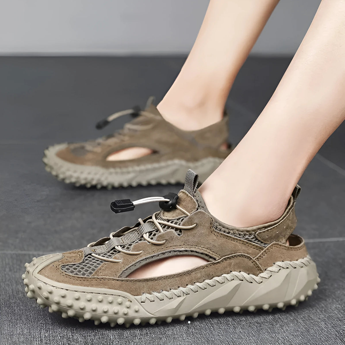 Men's black leather mesh sports sandals with elastic band and rubber sole.