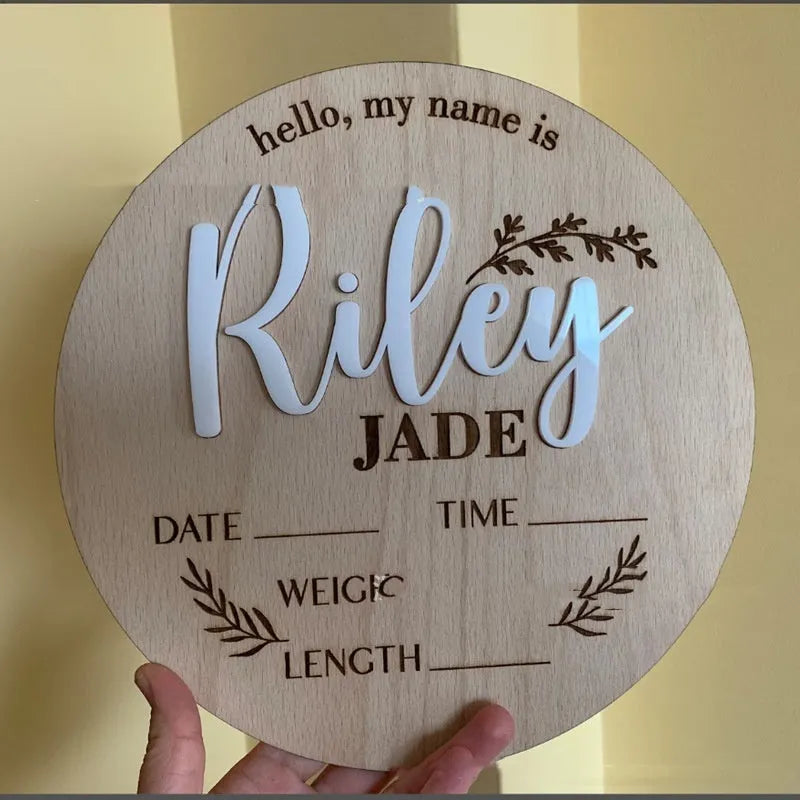 Square plywood baby birth announcement plaque showing spaces for name, date, weight, and height.
