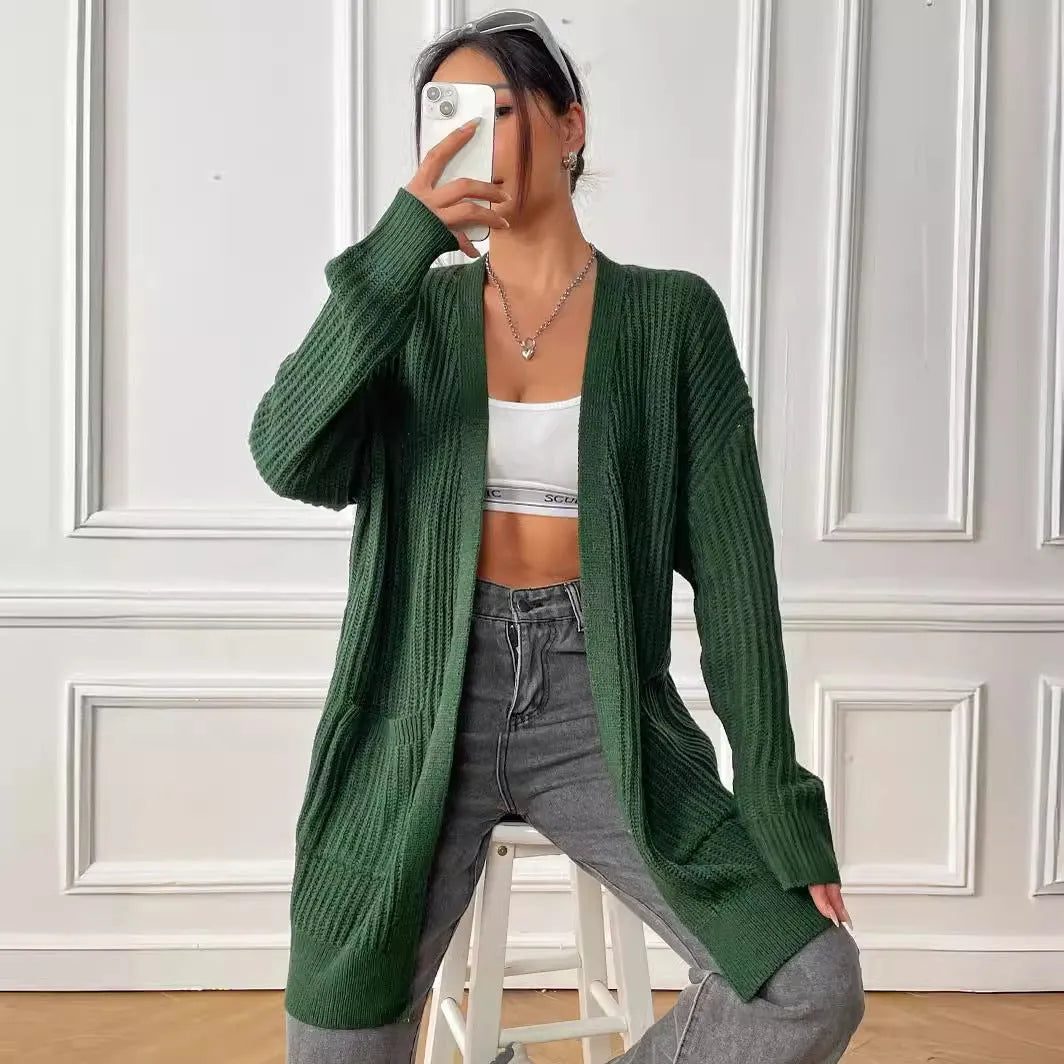 Women's dark green double pocket acrylic cardigan with long sleeves on a hanger.