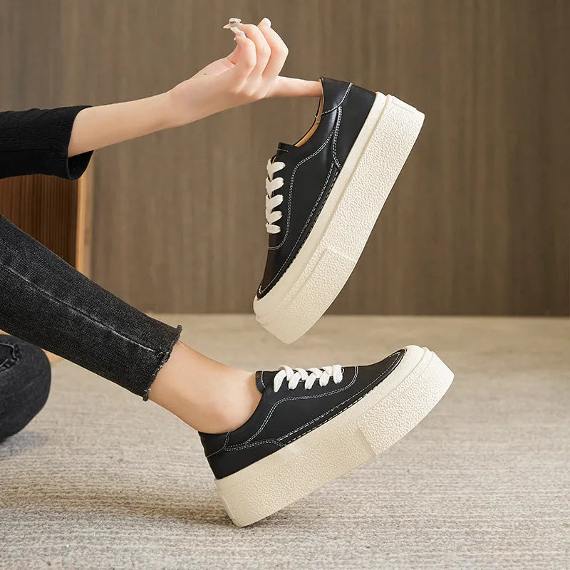 Women's black embossed leather platform sports shoes with a round toe and rubber sole.