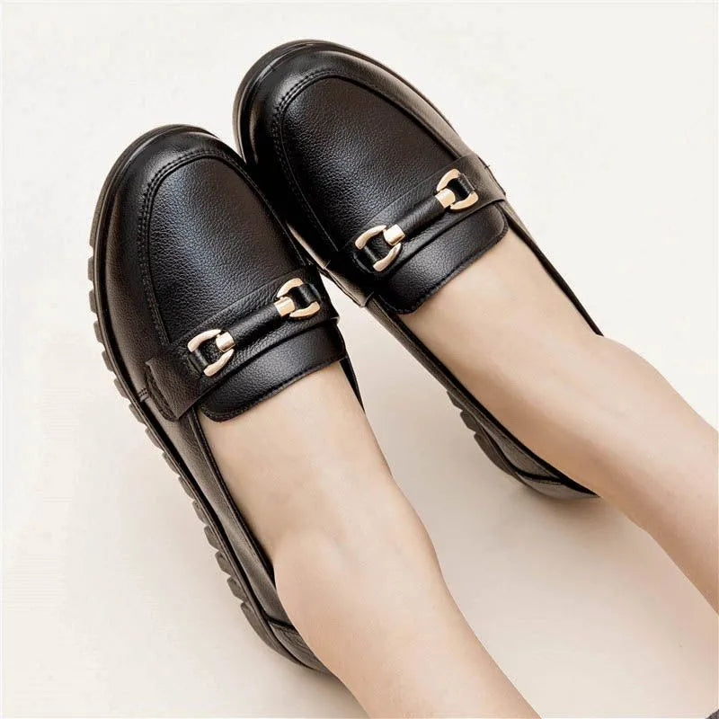 Black women's soft leather slip-on pumps with a rounded toe and low flat heel.