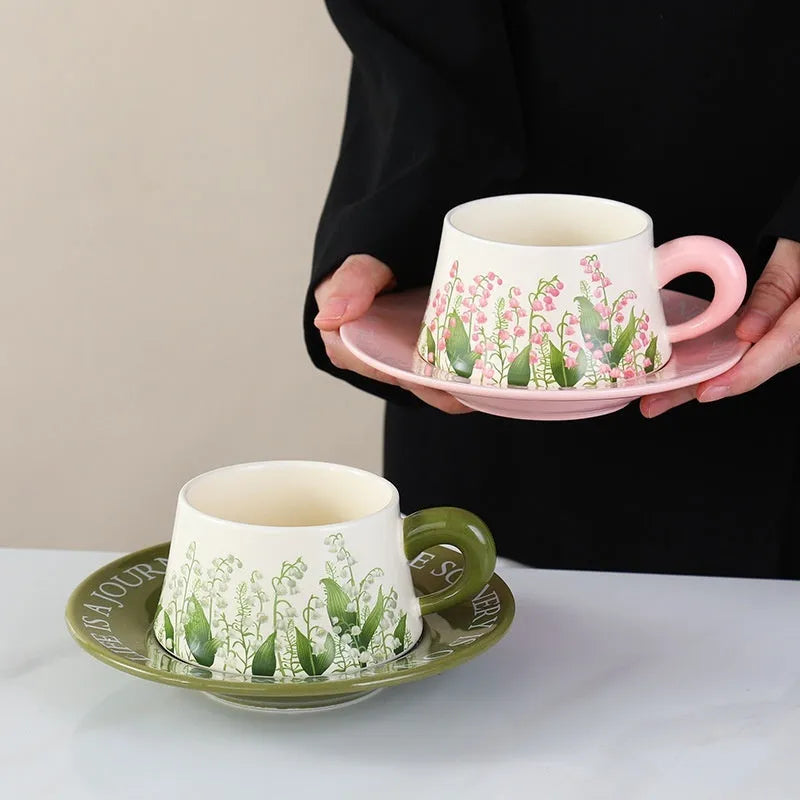 Ceramic coffee cup and saucer set with stirring spoons in Campanula or Lanling grass designs.