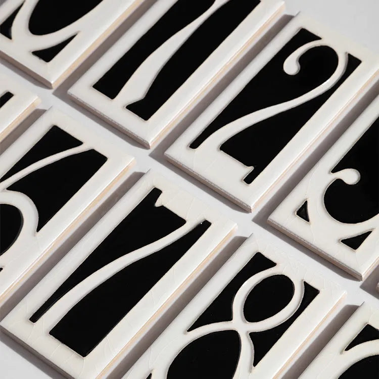 Handmade retro-style ceramic doorplate showing a number, measuring 76mm by 152mm.