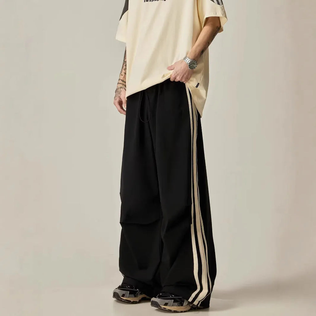 Black men's wide leg climbing trousers with a high waist and straight leg on a mannequin.