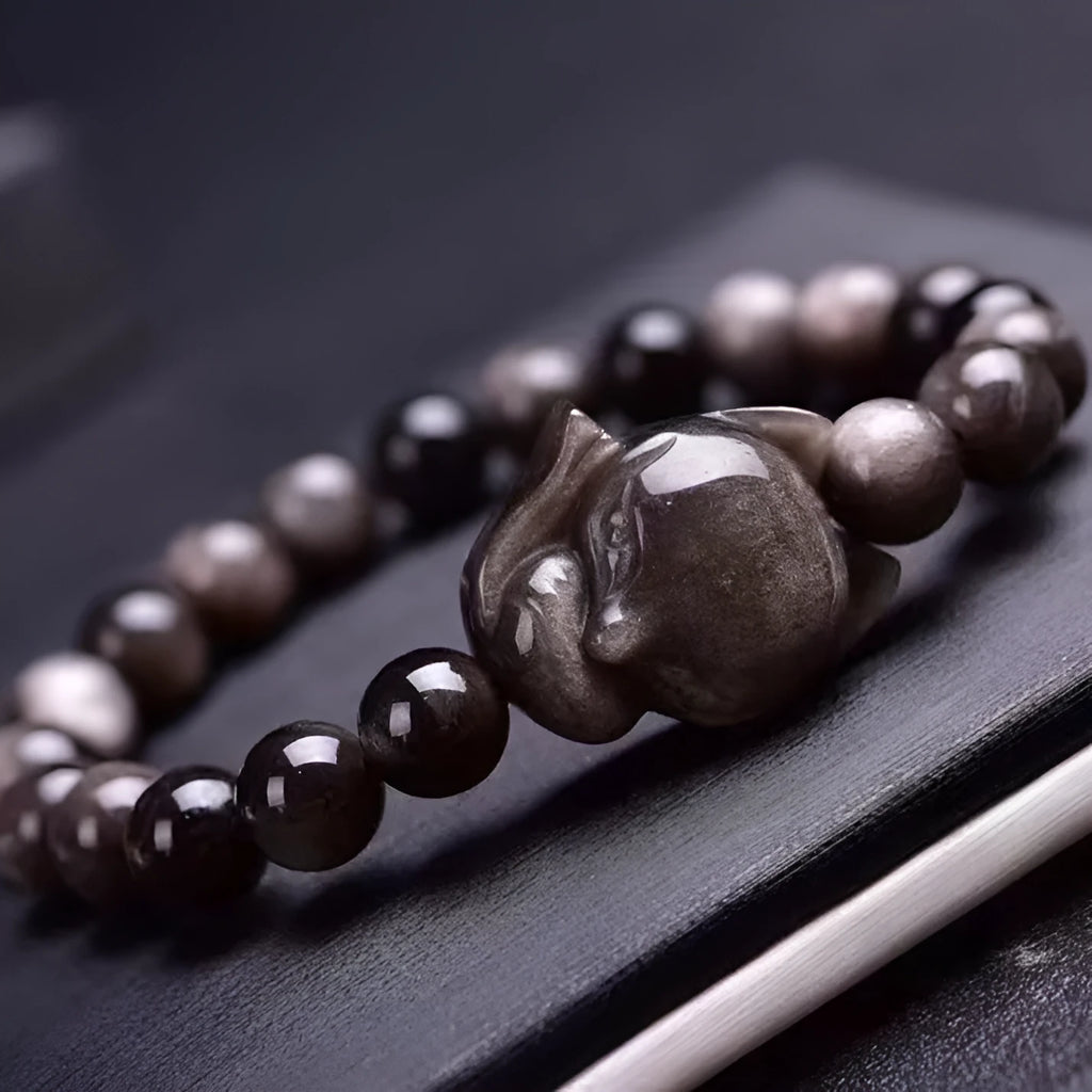 Obsidian fox single ring bracelet showing polished 8mm stone bead with detailed fox pendant on adjustable band