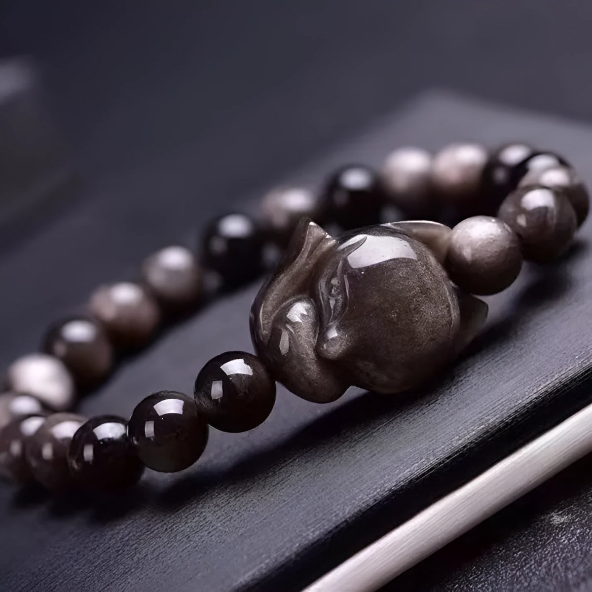 Obsidian fox single ring bracelet showing polished 8mm stone bead with detailed fox pendant on adjustable band