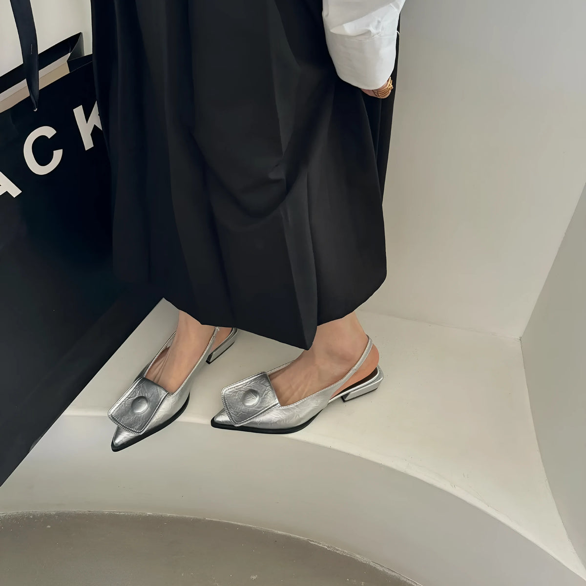 Women's low heel pointed toe sandals in apricot colour with a back strap and closed toe