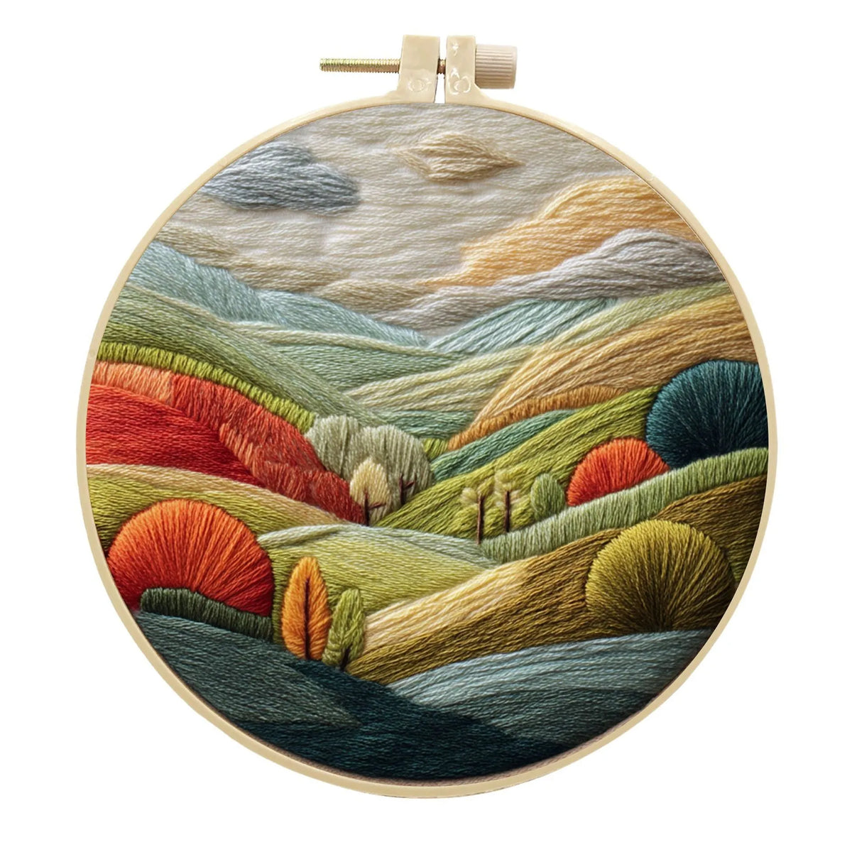 Embroidery DIY kit with cotton landscape fabric, bamboo frame, needles, and thread on wooden table