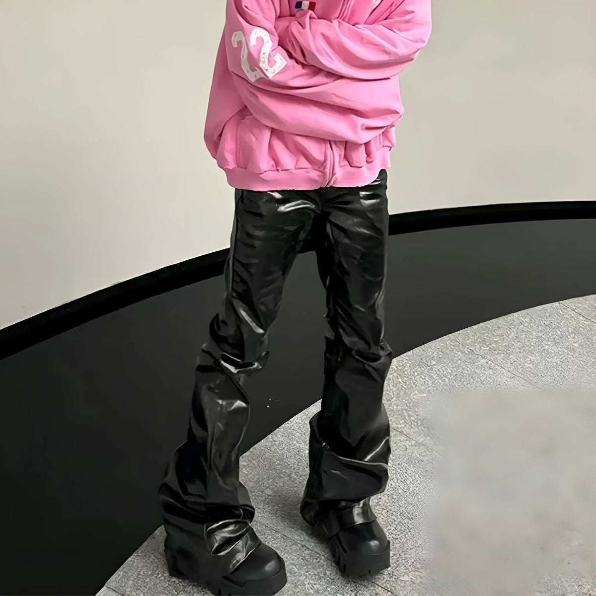 Black shiny patent leather skinny jeans with mid waist and straight leg on a model