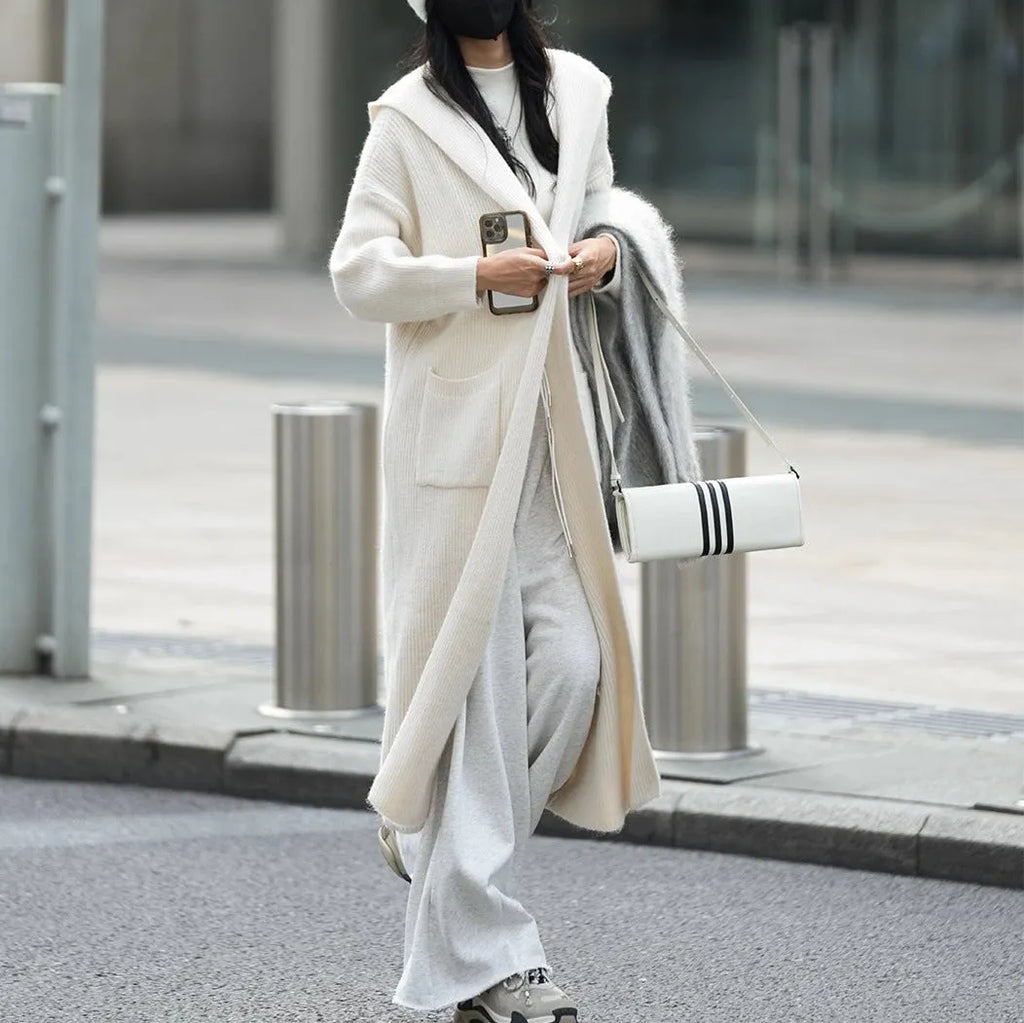 Long grey knitted cardigan with hood in trench coat style, showing wool blend fabric texture and 80cm length