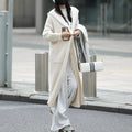 Long grey knitted cardigan with hood in trench coat style, showing wool blend fabric texture and 80cm length