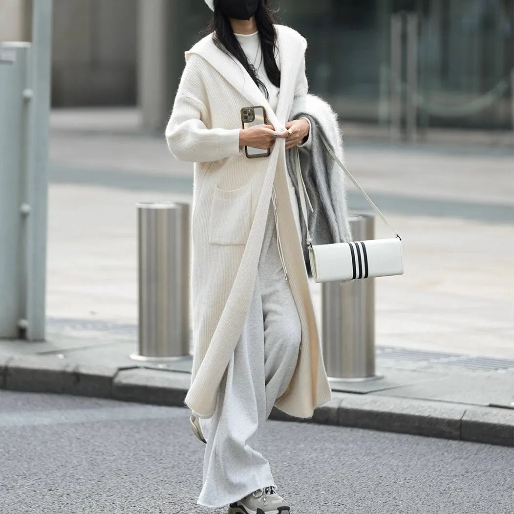 Long grey knitted cardigan with hood in trench coat style, showing wool blend fabric texture and 80cm length