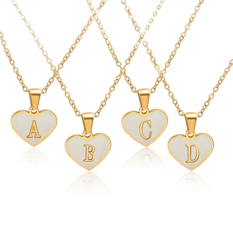 Gold-plated heart-shaped white shell necklace with adjustable chain and letter personalisation option