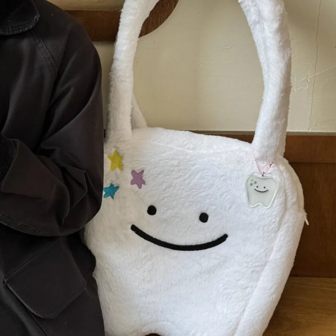 White plush shoulder tote bag with large tooth design and cute teeth pattern, showing zipper closure