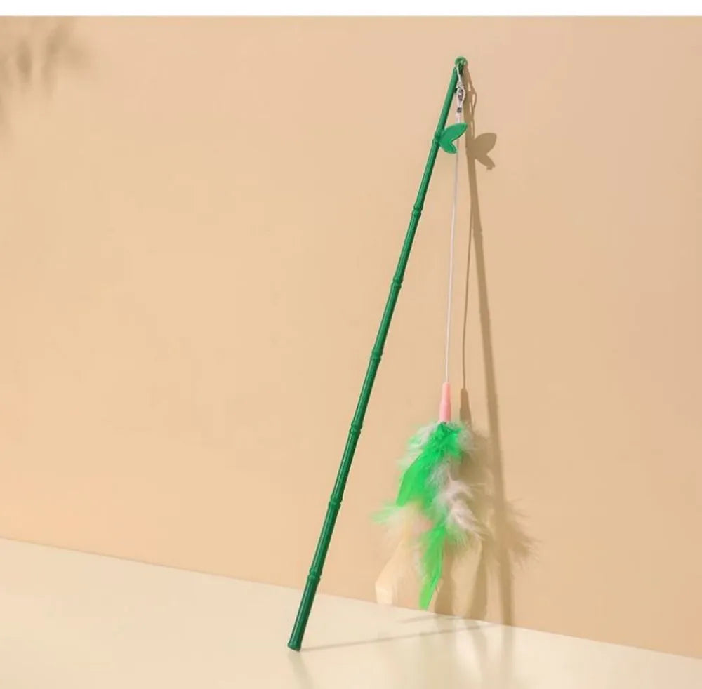 Green interactive cat feather wand toy with bell and feather attachments for indoor play