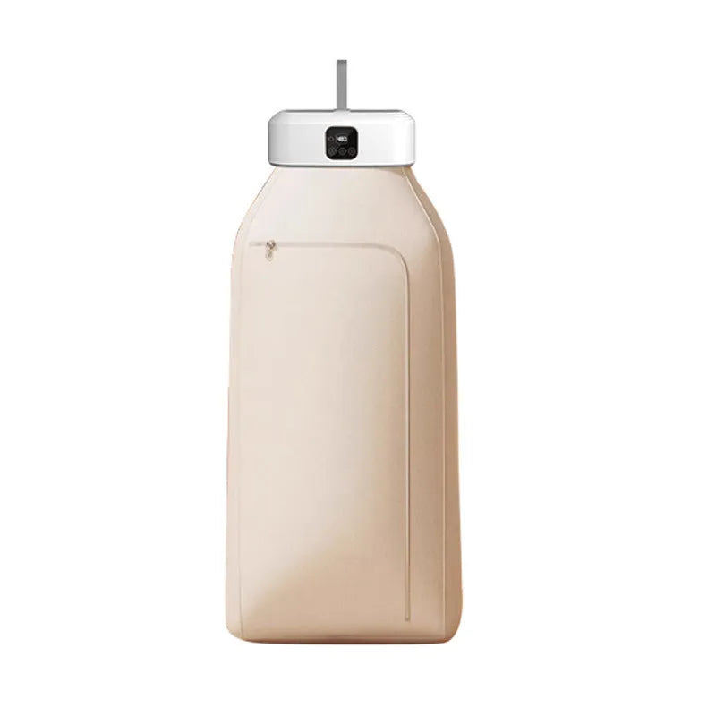 White cylindrical compact electric clothes dryer with remote control on a table.
