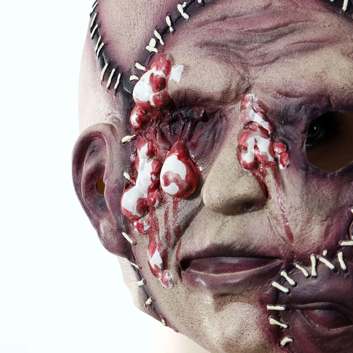 Latex three-sided Grimace horror Halloween mask for adults on a black background.
