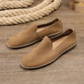 Handmade grey low-top men's shoes with a flat wedge heel and rubber sole.