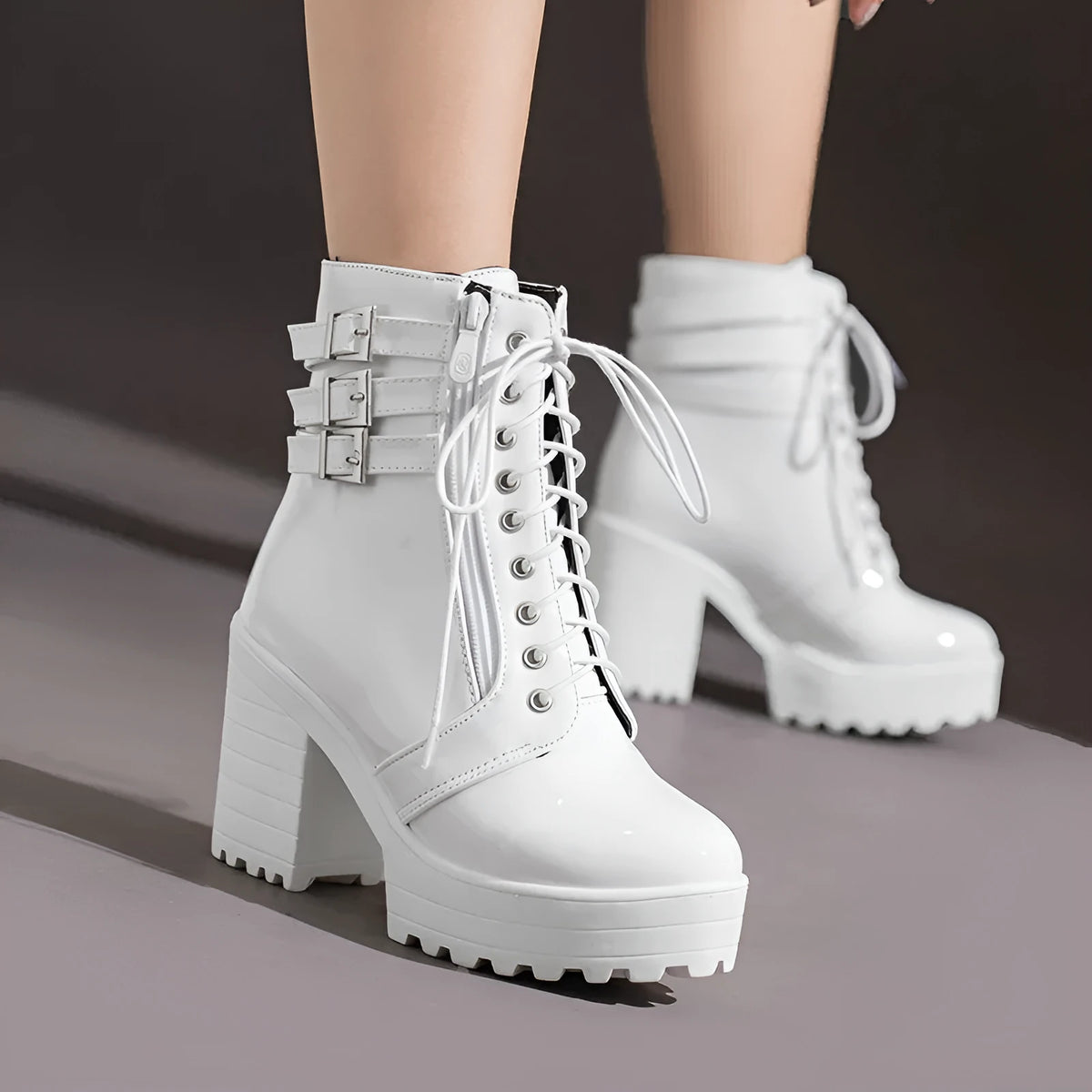 Women's black thick-heeled short boots with lace-up front and waterproof platform on a rubber sole.