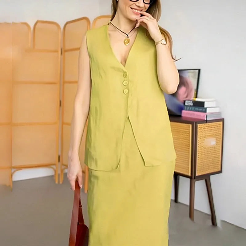 A woman wearing a blue sleeveless top and matching long skirt from a casual two-piece suit set.